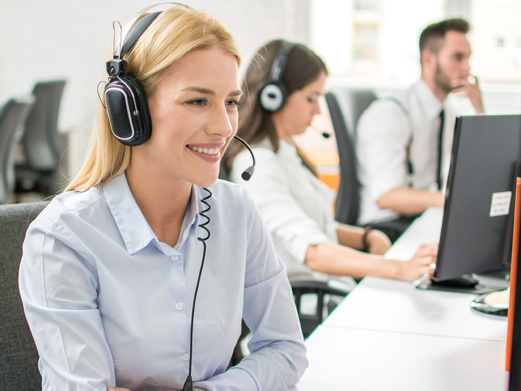 A smiling call center employee at an in-house call center