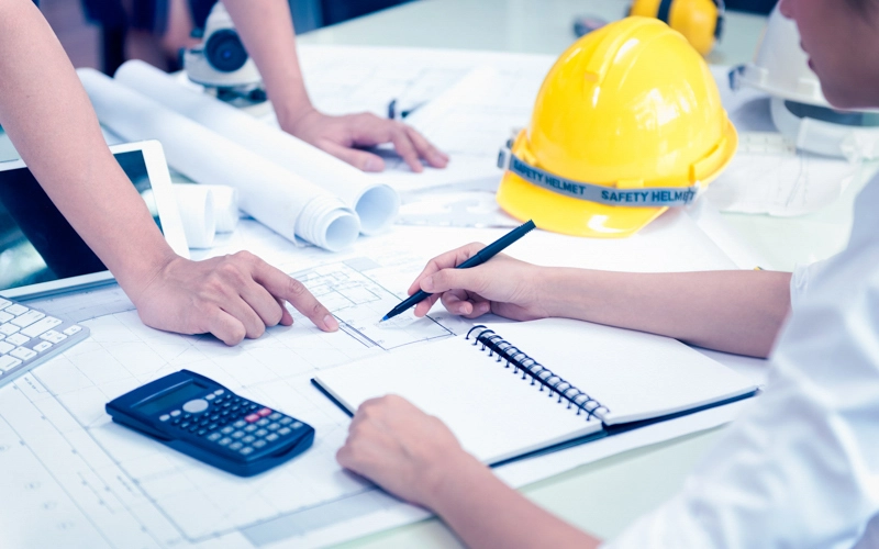 Construction employees reviewing plans