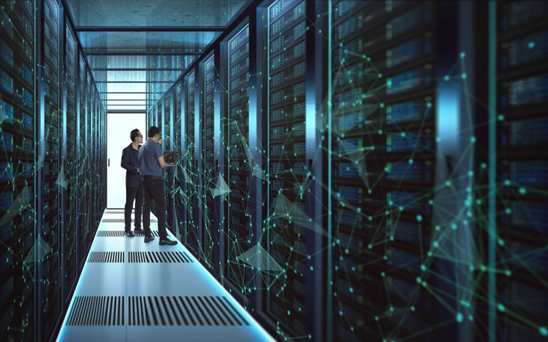 Two employees reviewing data center infrastructure